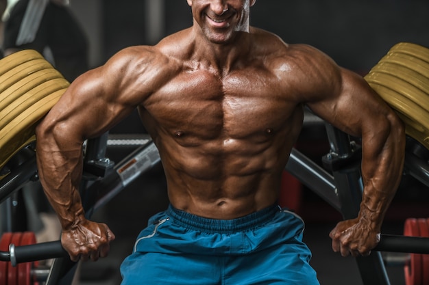 Brutal aged strong bodybuilder athletic men pumping up muscles with dumbbells