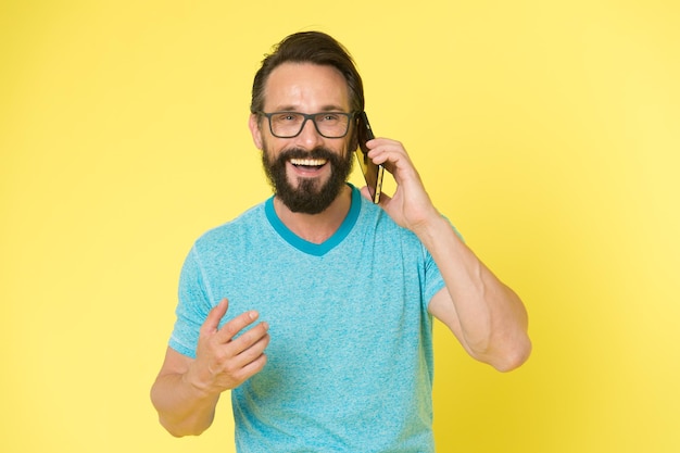 Brutal caucasian hipster with moustache happy conversation Business Bearded man speaking on phone modern life with digital technology Mature hipster with beard Confident and handsome Brutal man