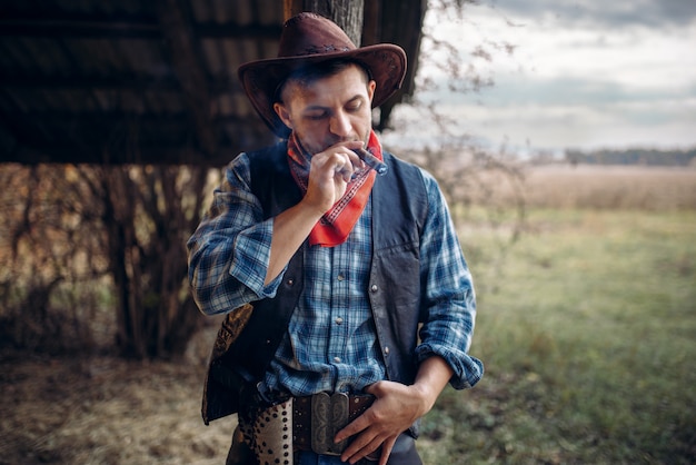 Brutal cowboy smokes a cigar, wild west culture