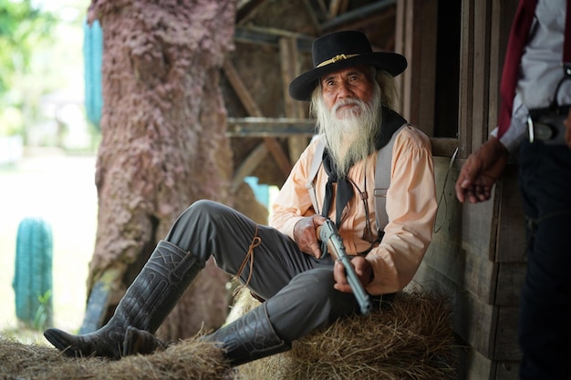 Brutal cowboy with his hand on revolver wild west