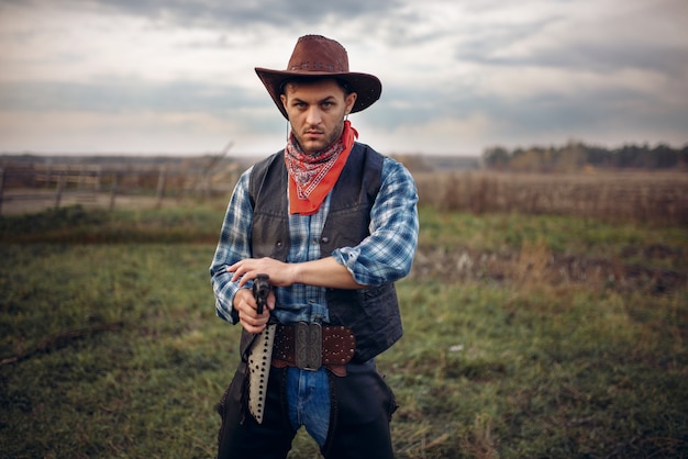 Brutal cowboy with revolver, gunfight on ranch