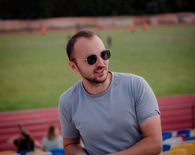 Brutal man with beard and sunglasses smiling