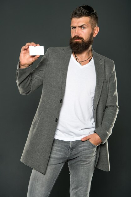 Brutal man with hipster beard. Bearded man. Male formal fashion. Businessman with credit card. Business fashion and dress code. confident businessman in suit. Mature. Work hard play hard.