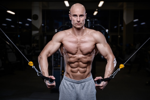 Brutal strong bodybuilder athletic men pumping up muscles with dumbbells