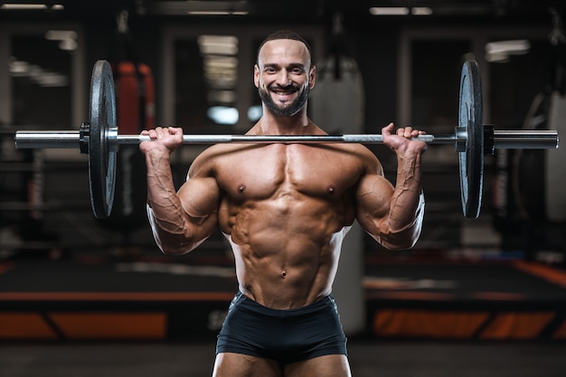 Brutal strong bodybuilder athletic men pumping up muscles with dumbbells