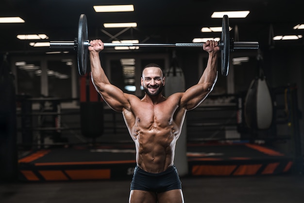 Brutal strong bodybuilder athletic men pumping up muscles with dumbbells