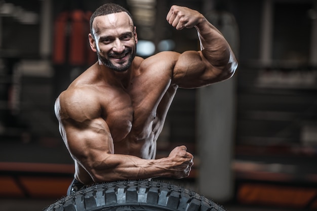 Brutal strong bodybuilder athletic men pumping up muscles with dumbbells