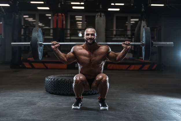 Brutal strong bodybuilder athletic men pumping up muscles with dumbbells