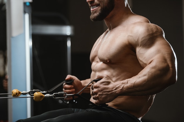 Brutal strong bodybuilder athletic men pumping up muscles with dumbbells