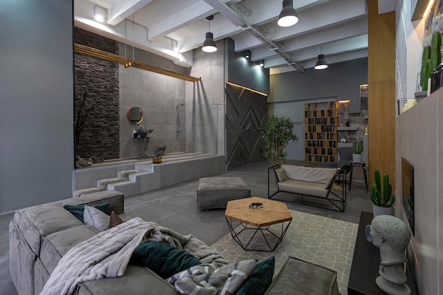 Brutal ultra trendy interior design of an openplan apartment with an open shower decorated with gray stone