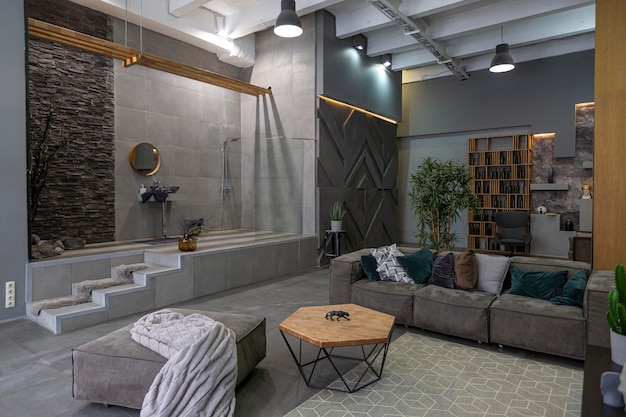 Brutal ultra trendy interior design of an openplan apartment with an open shower decorated with gray stone