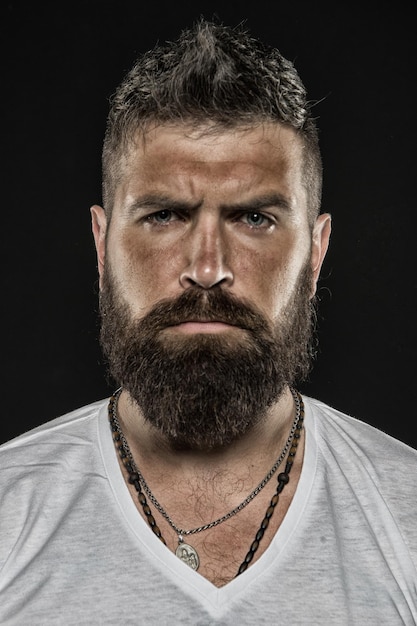 Brutality and masculinity Man bearded hipster serious face close up Brutal man with over suntanned skin face Hipster with beard and mustache looks strict and brutal Brutal masculine appearance