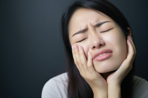 Photo bruxism symptoms in women portrait of exhausted stressed asian woman grinding teeth while