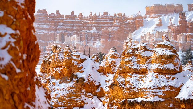 bryce canyon national park in winter, unique rock formations in utah covered in snow, orange rocks