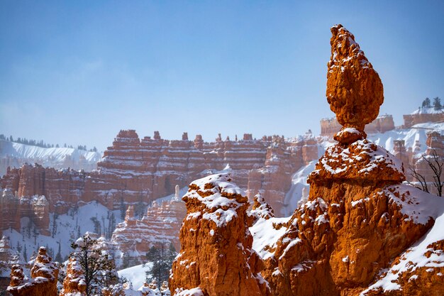 Bryce canyon national park in winter, unique rock formations in\
utah covered in snow, orange rocks