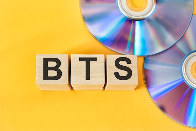 BTS concept with wooden cubes BTS word on CD background