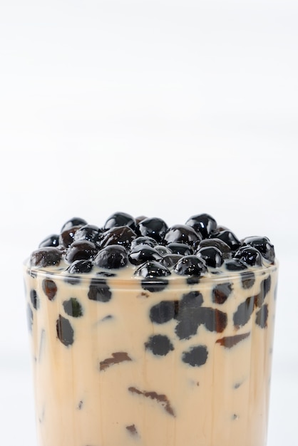 Bubble milk tea with tapioca pearl topping, famous Taiwanese drink on white wooden table