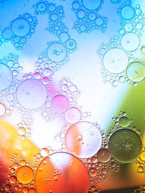 Bubbling liquid against multicolored background