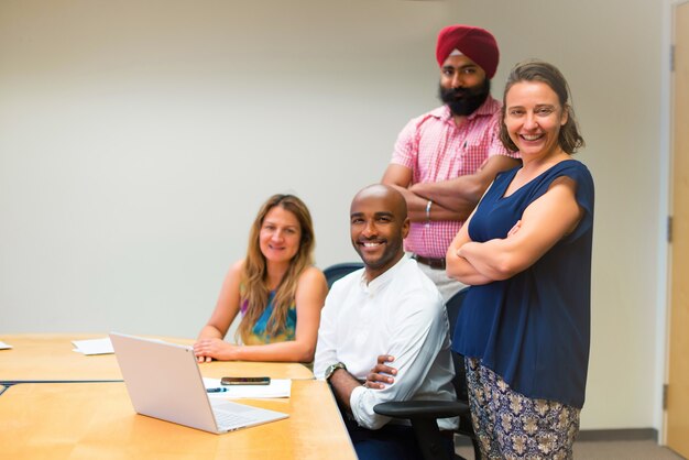 bubsiness team formed by different ethnics in the office with laptop