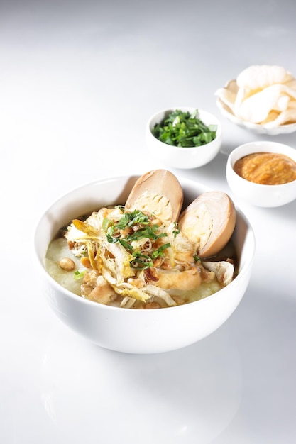 Bubur Ayam or Indonesian Rice Porridge with Shredded Chicken and Cakwe.