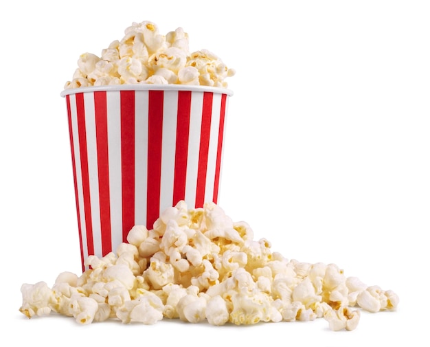 Photo a bucket of popcorn is next to a pile of popcorn