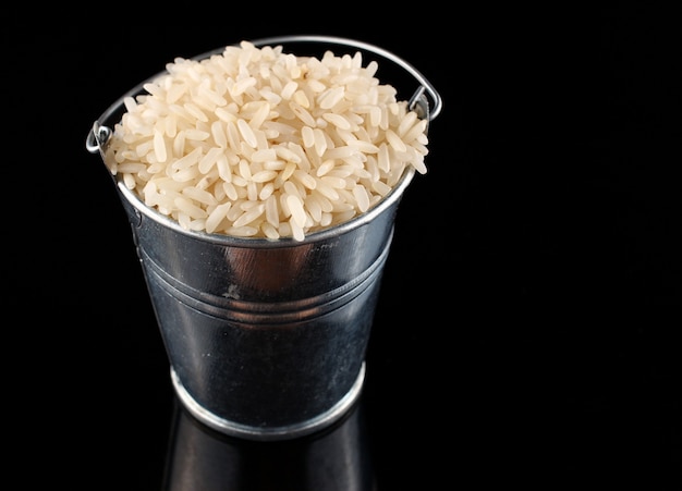 A bucket of rice on black