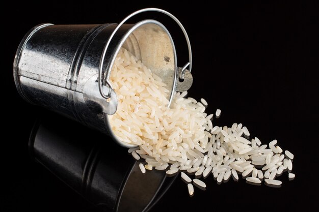 A bucket of rice on black