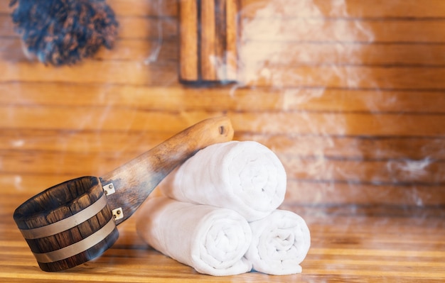 Bucket and white towels in sauna