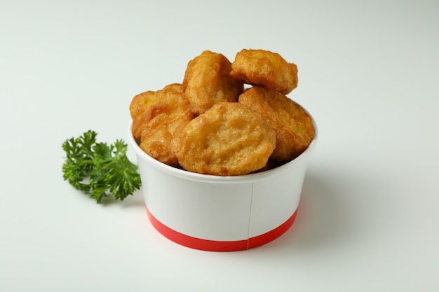 Bucket with fried chicken on white background