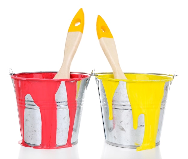 Buckets of paints with brushes isolated on white