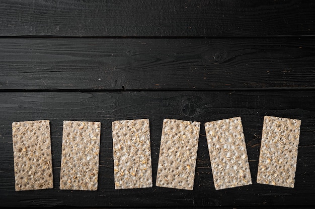 Buckwheat crisp bread set, on black wooden table, top view flat lay