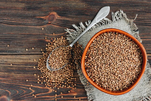 Buckwheat on dark wooden surface.