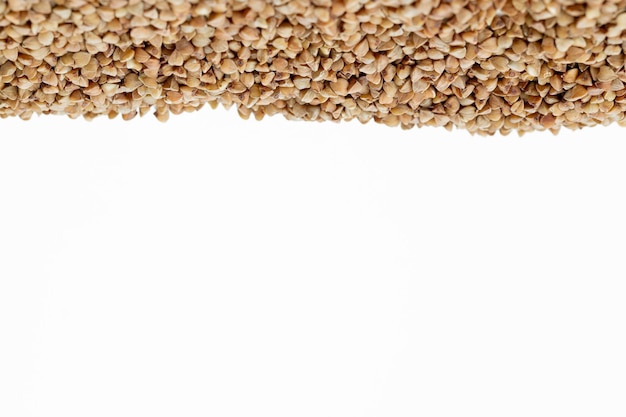 Buckwheat grain isolated on white background close up with copy space for your text