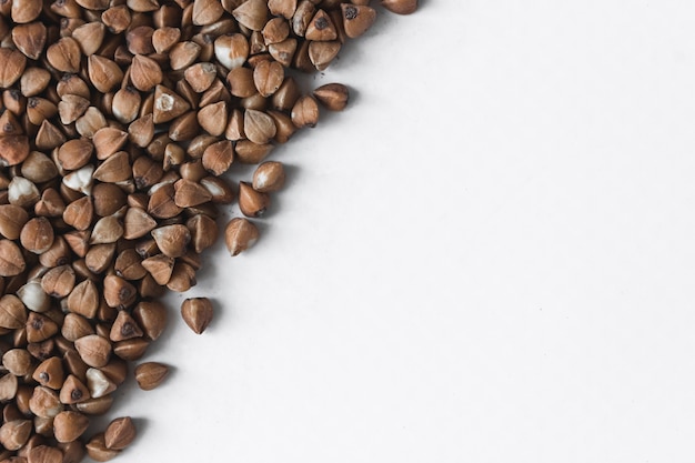 Buckwheat grains on a white background. A place for text.