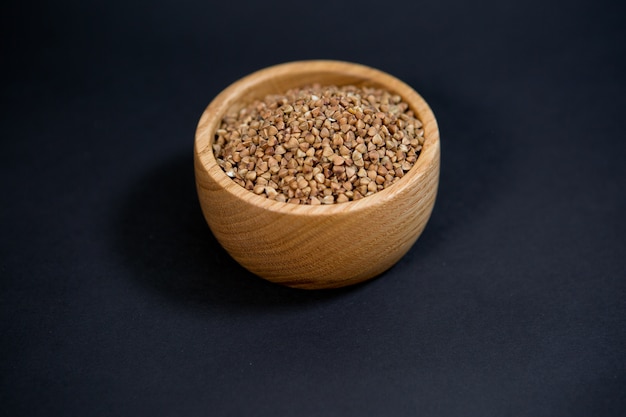 Buckwheat grains in a wooden Cup