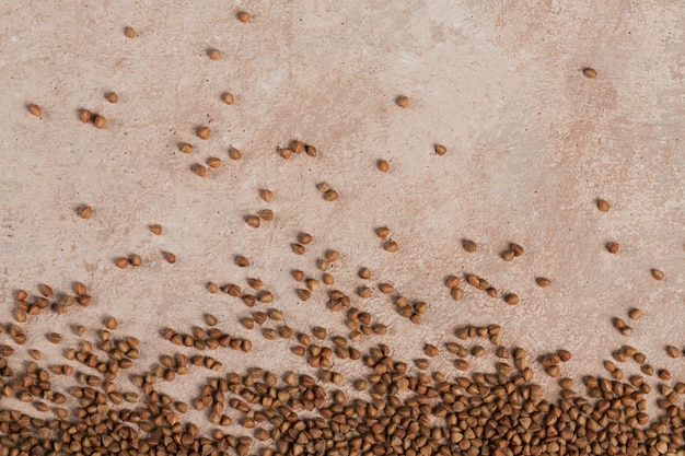 Buckwheat groats close up. Grains of raw buckwheat as a abstract texture.