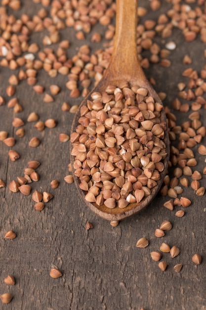 Buckwheat groats on wooden background