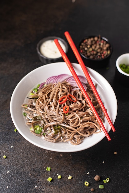 Buckwheat noodles soba fresh portion ready to eat meal snack on the table copy space food