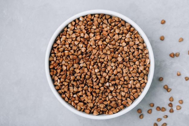 Buckwheat Organic raw dry Buckwheat grains in bowl on gray stone background