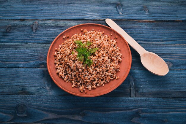 Photo buckwheat on a plate on a wooden background top view copy space