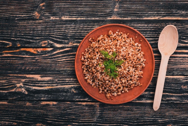 Buckwheat on a plate On a wooden background Top view Copy space