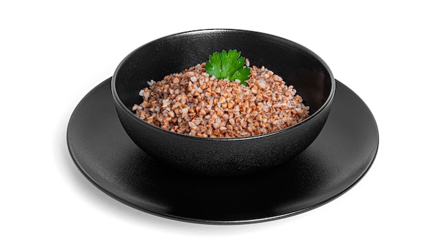 Buckwheat porridge in black bowl isolated.