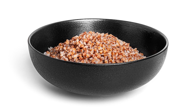 Buckwheat porridge in black bowl isolated.