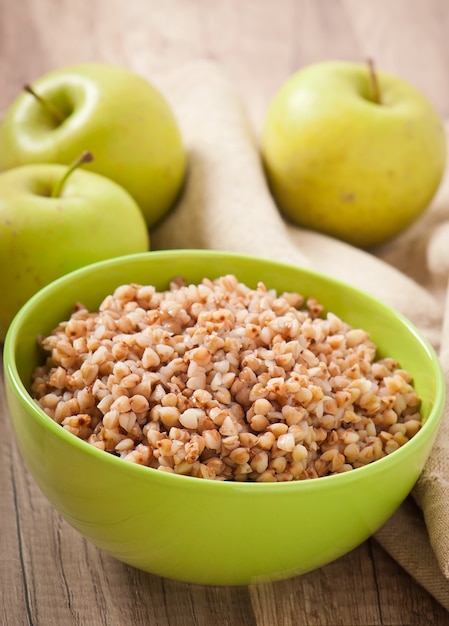 Buckwheat porridge in a bowl on a wooden table