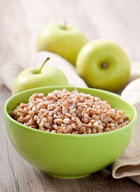 Buckwheat porridge in a bowl on a wooden table