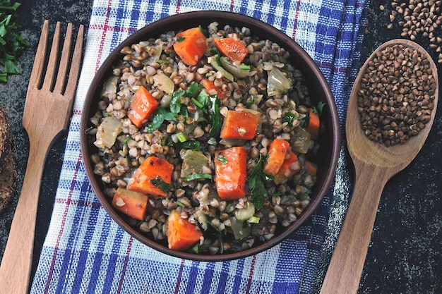 Buckwheat porridge with vegetables in a bowl. View from above.