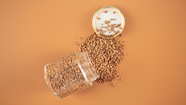 Buckwheat scattered all over trivets from a  bowl on brown backround