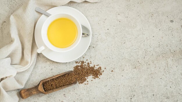 Buckwheat tea in the white cup and buckwheat tea brew Ku Qiao tea with copy space top view