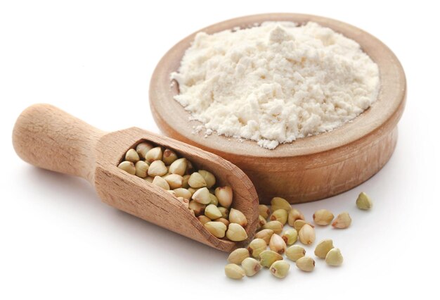 Buckwheat with flour over white background