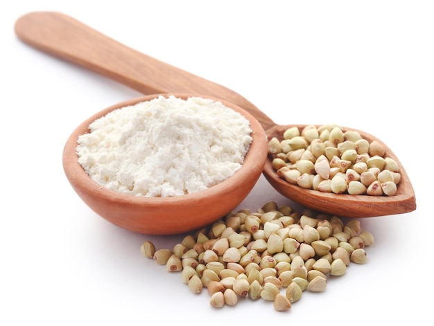 Photo buckwheat with flour over white background